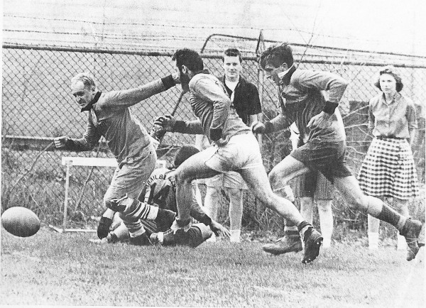 An unknown player, Warren Sublette, and Mike Burrows race for the ball.