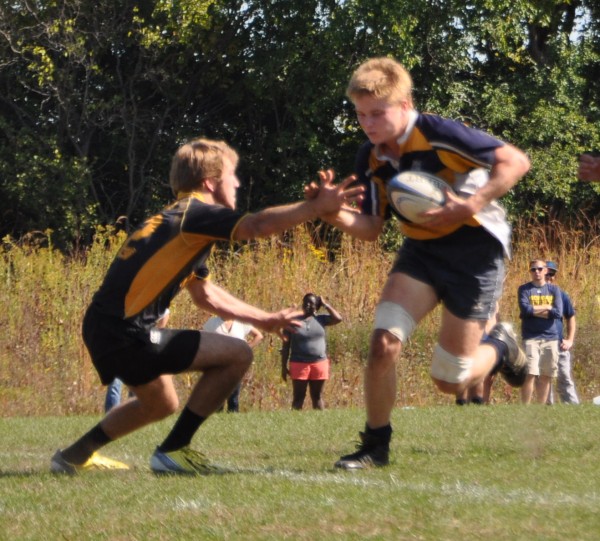 Jesse Fenno side steps and high fives a defender before scoring for Michigan