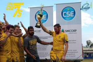 Captain Zack Boourns wielding the first place trophy the same way he does with the ball, above his head